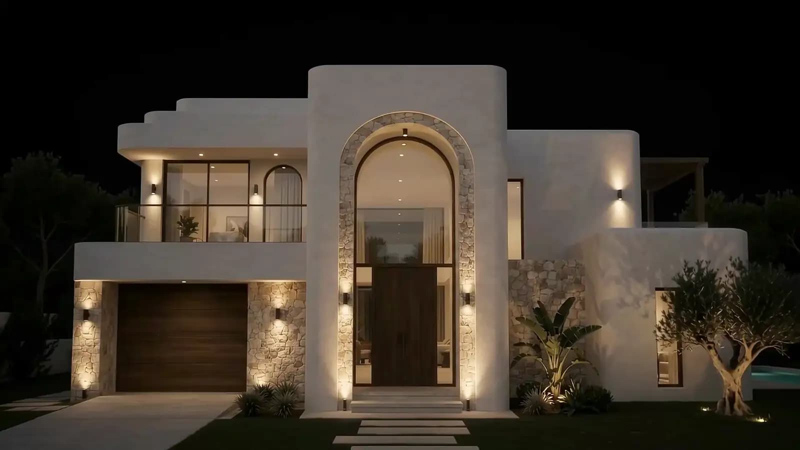 A contemporary luxury villa at night, its arched stone entrance and interior warmly lit against a black sky